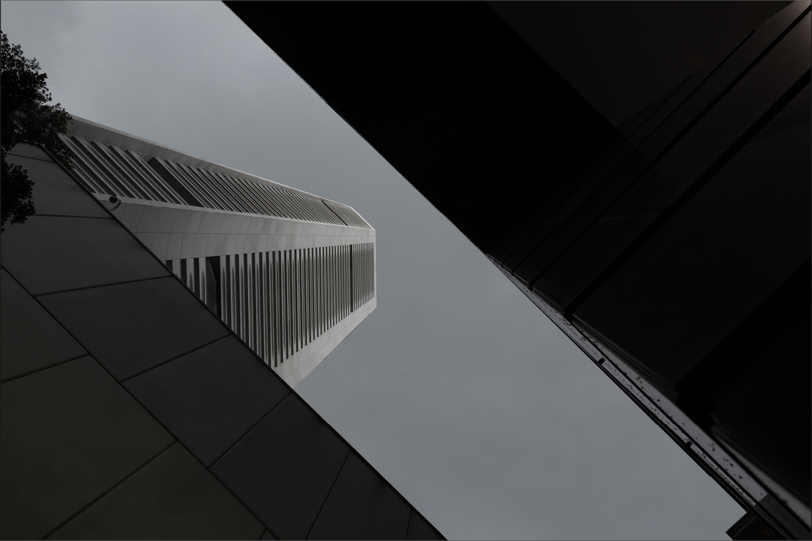 Modern buildings viewed from below against a cloudy sky - Used on Capco Insights