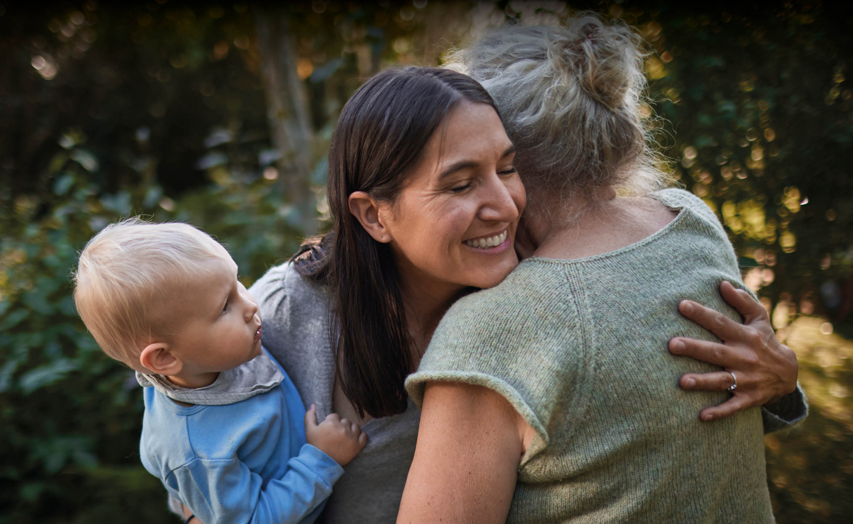 Capco: Consumer - A woman and her young baby are seen hugging an elderly woman.