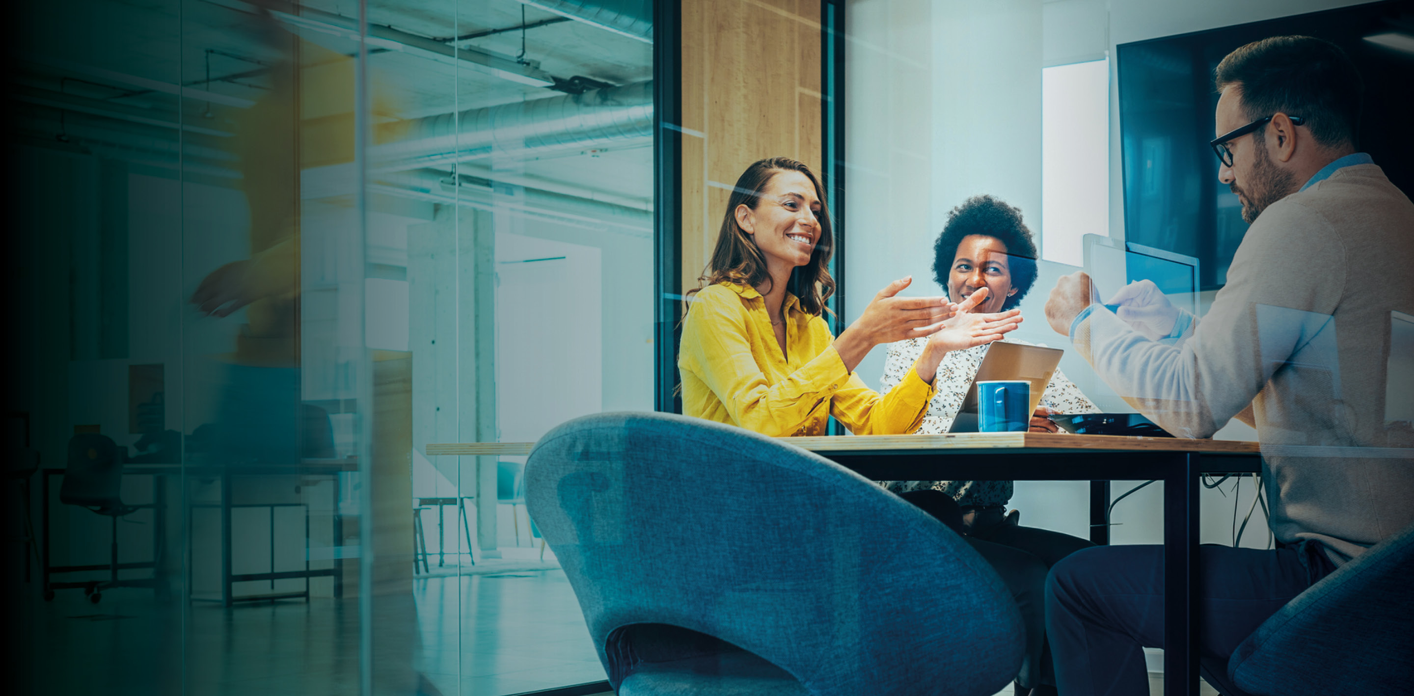 Business people in Conference Room and Colleagues Walking By. Blurred motion of colleagues walking briskly down office hallway as colleagues sit in conference room discussing ideas. Busy modern workplace. Working process in the office, business people working, walking and talking, blurred motion