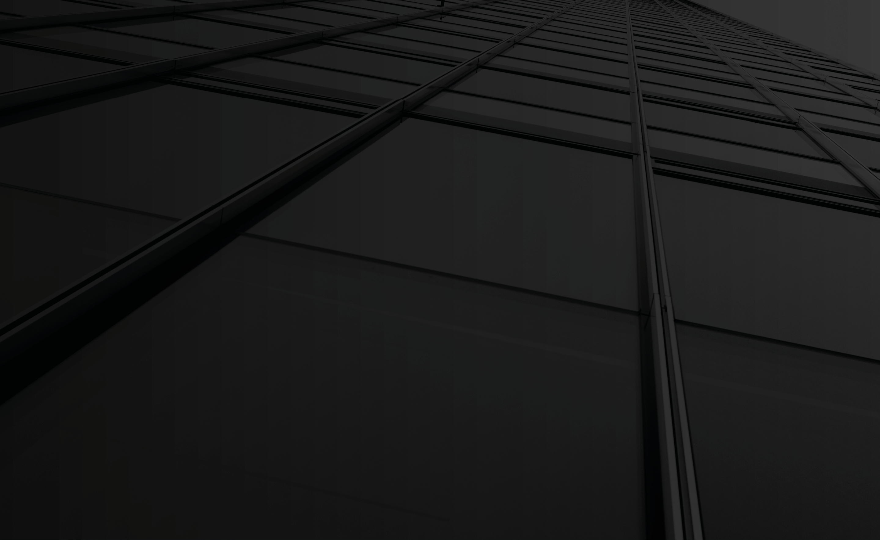 Upward view of a modern glass skyscraper, symbolizing scale, stability, and growth.