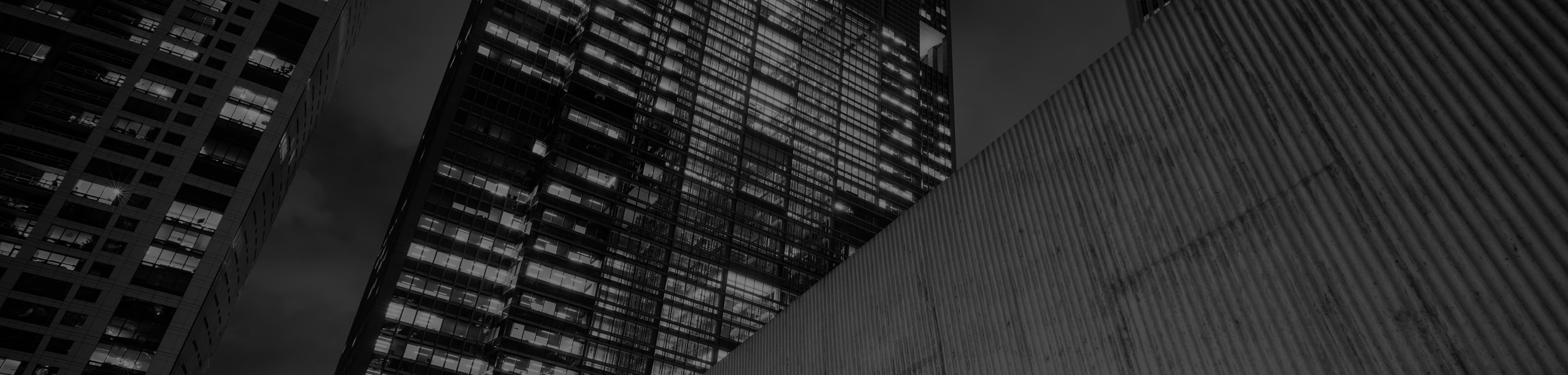 Modern office towers viewed from below, symbolizing innovation, governance, and enterprise technology.