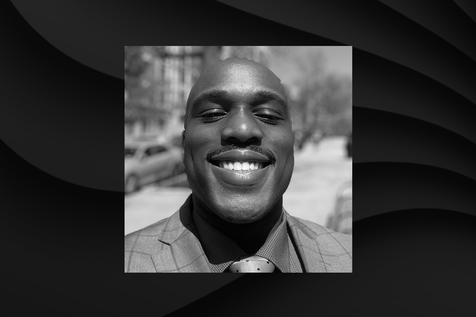Black and white headshot of Zuberi Daley smiling